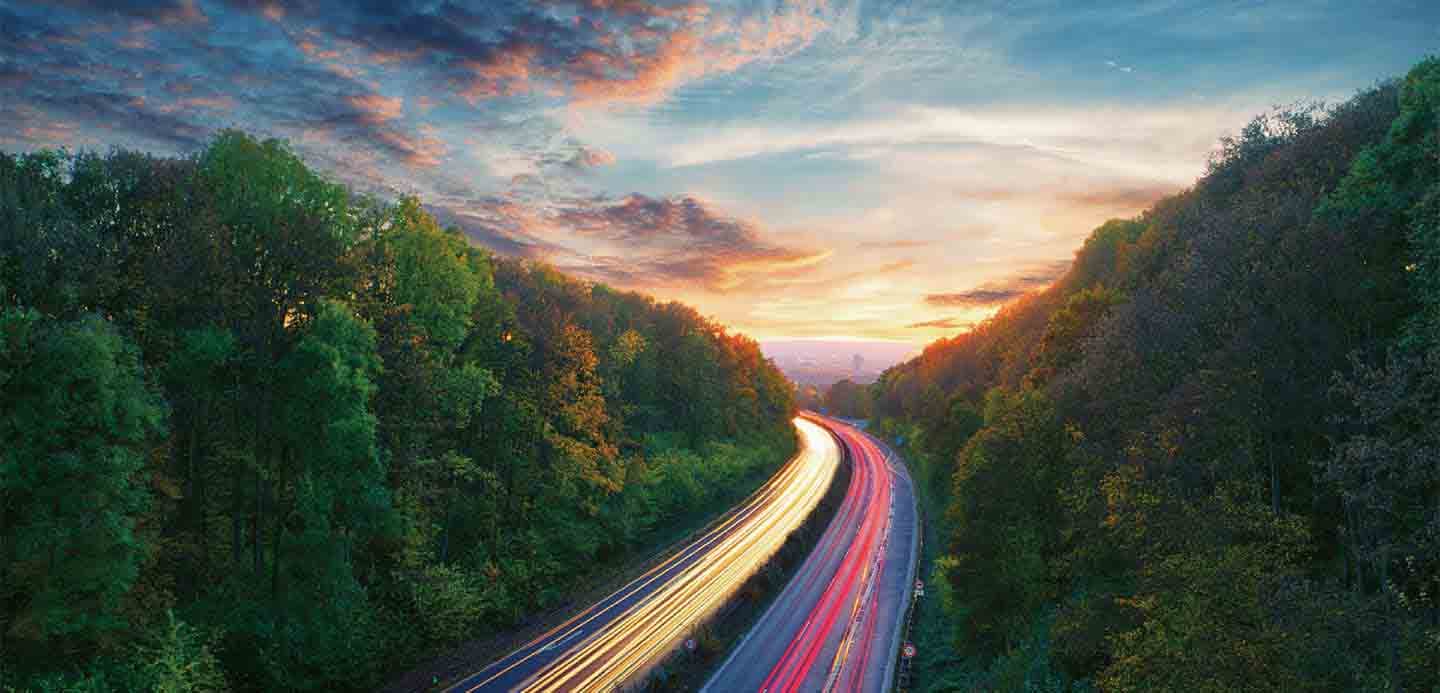 highway surrounded by forest highway surrounded by forest